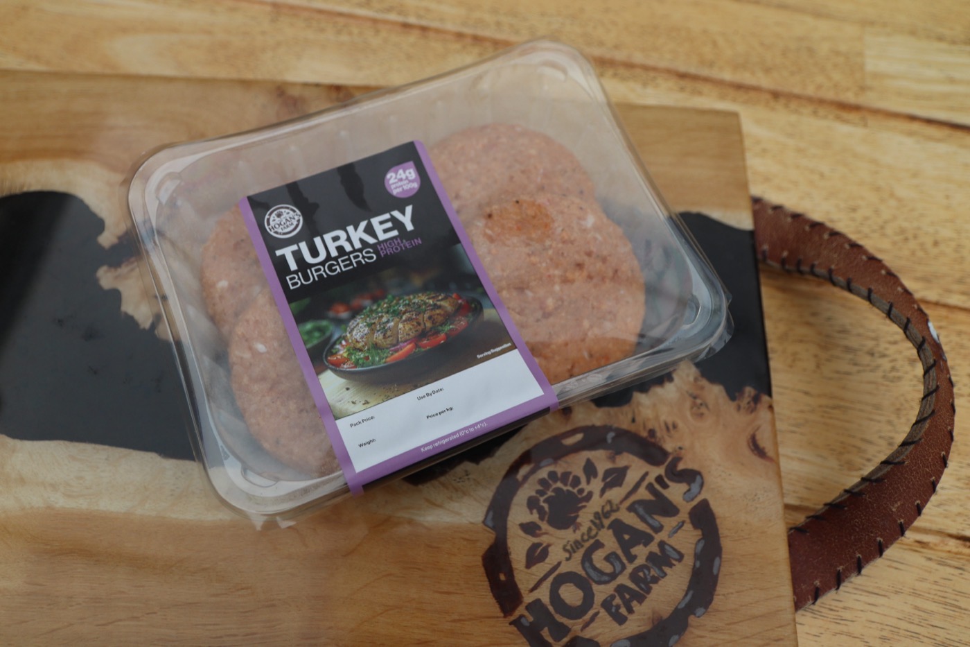 Hogan’s Farm original turkey burgers pack on a branded wooden board
