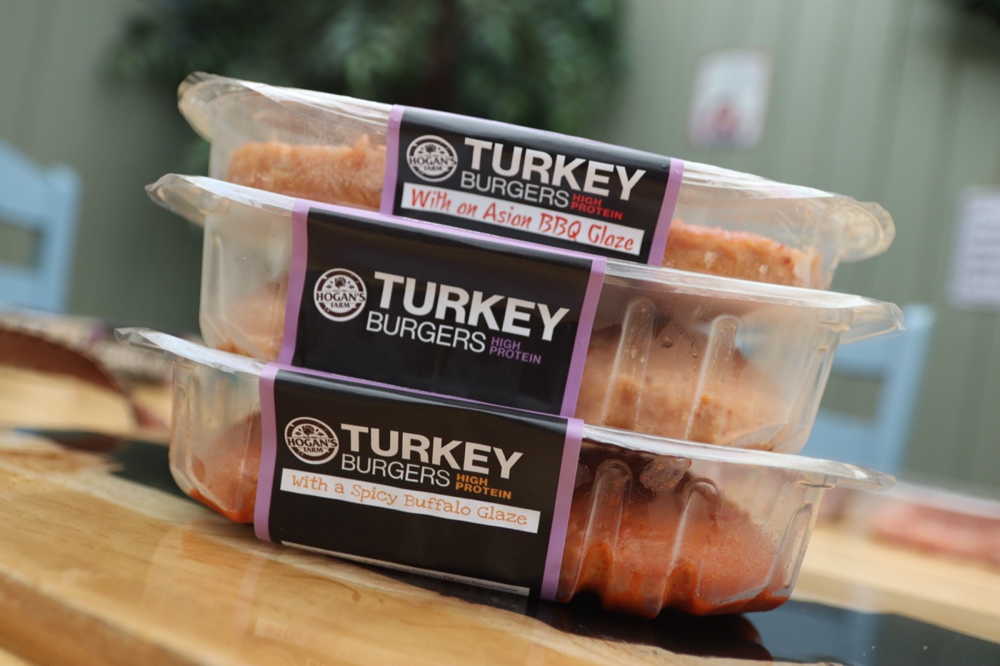 Stack of Hogan’s Farm turkey burger packs in different glazes